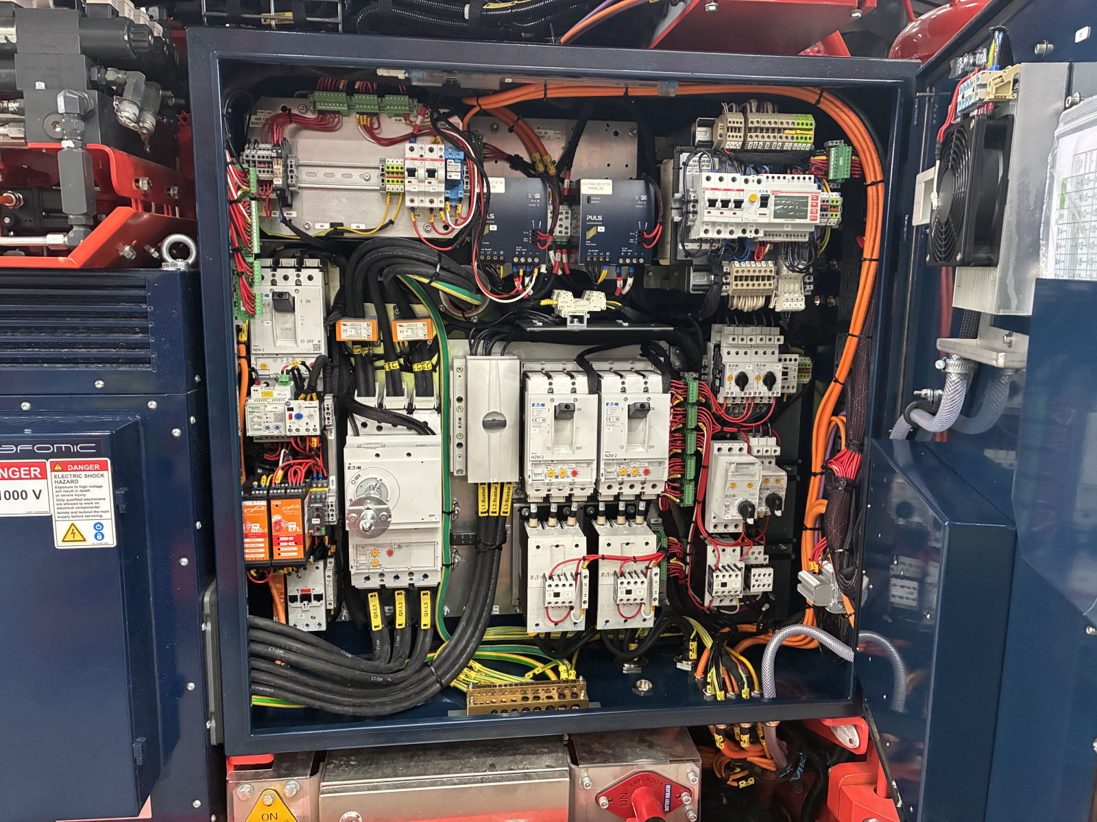 Underground drill rig control panel with protection devices and labelled control wiring