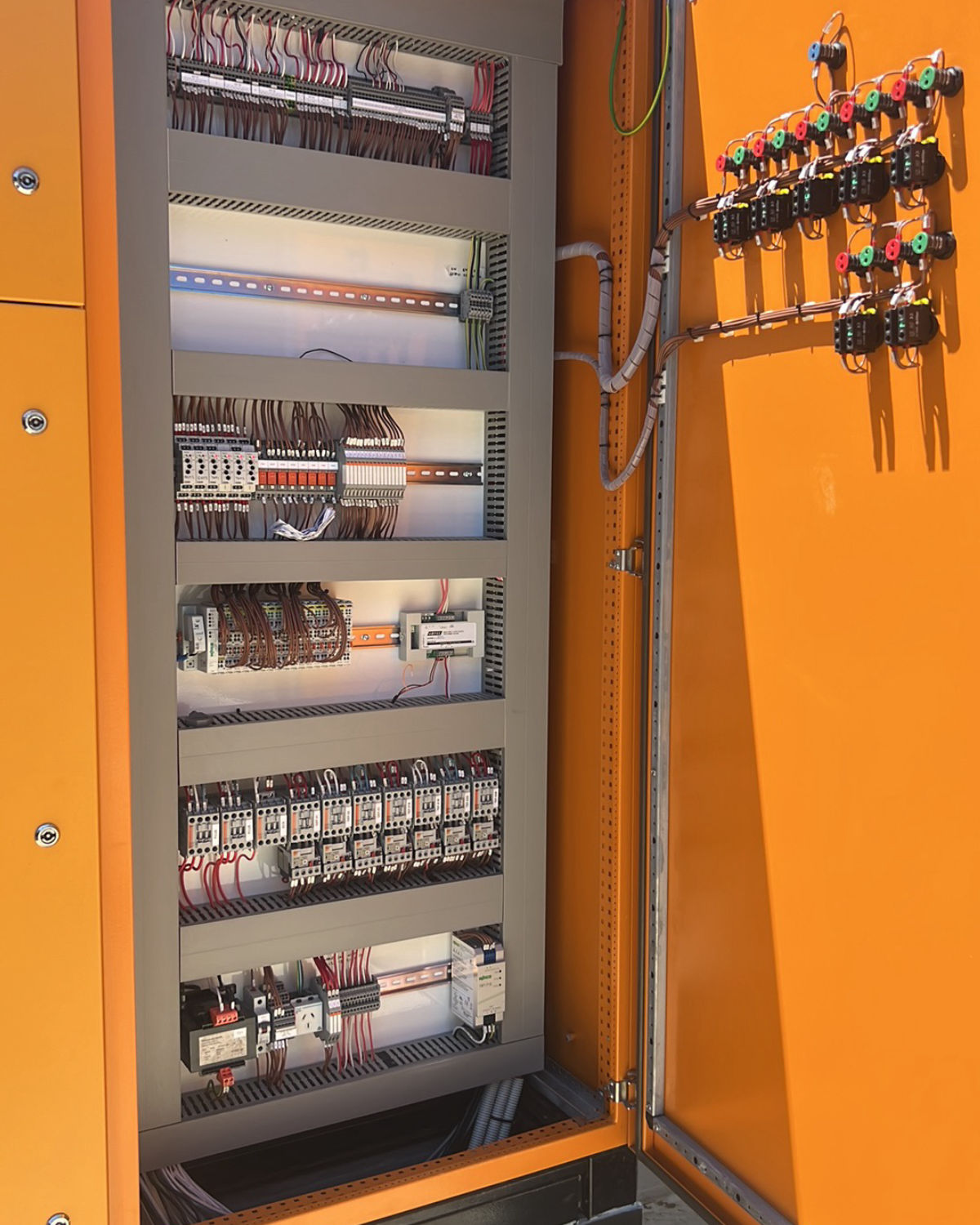 Completed motor control cabinet with contactor banks, control wiring and door-mounted control stations